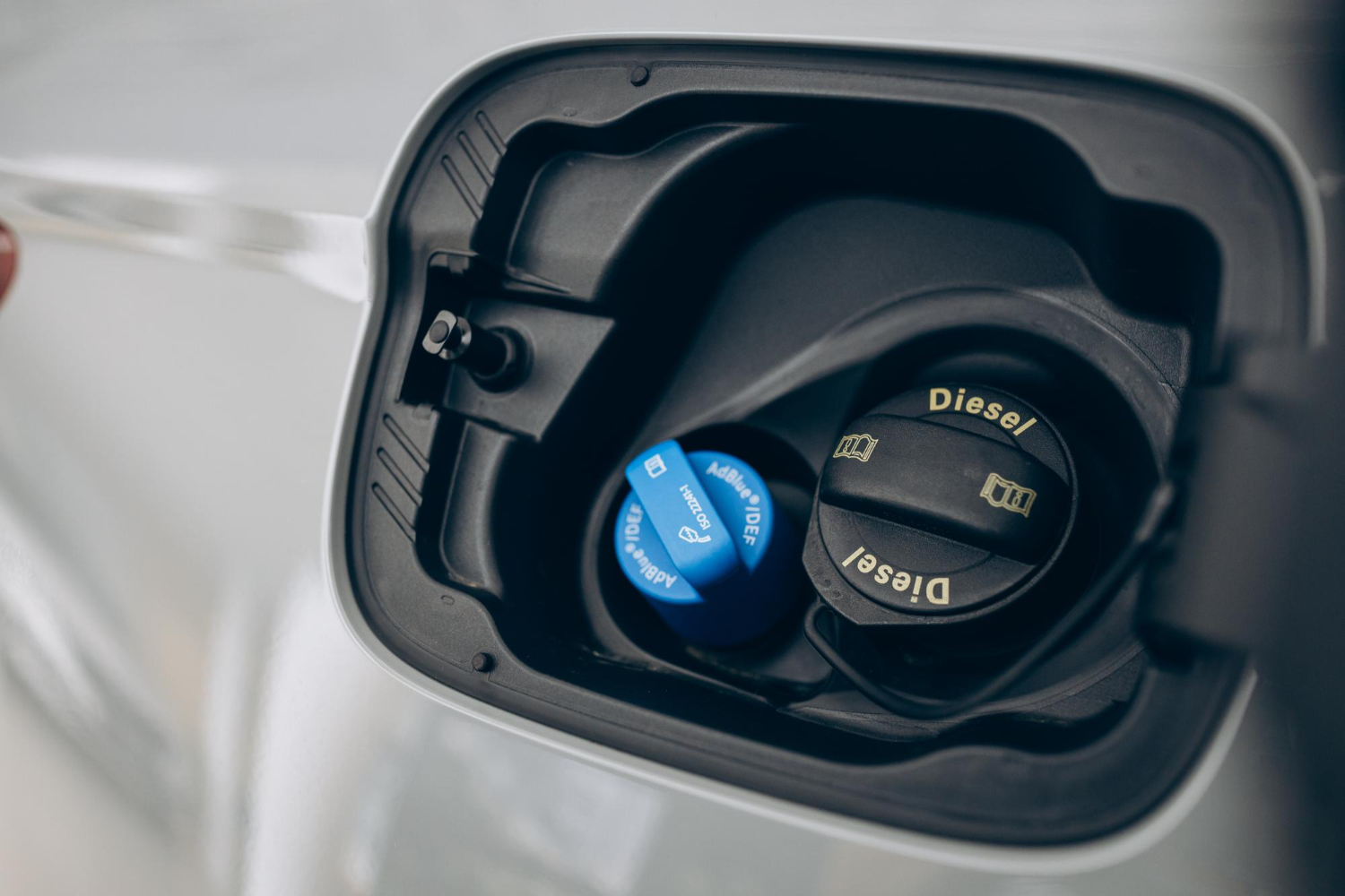 gas tank cover opened showing the diesel refill port
